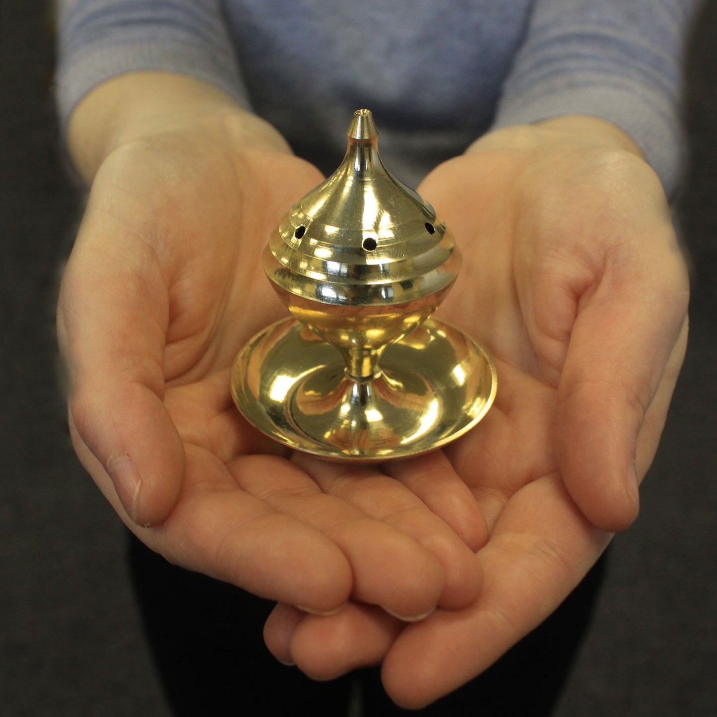 Image: Medium Brass Incense Burner - Traditional and functional, perfect for burning incense. Great for creating a serene atmosphere. Image shows palm of hands holding incense holder