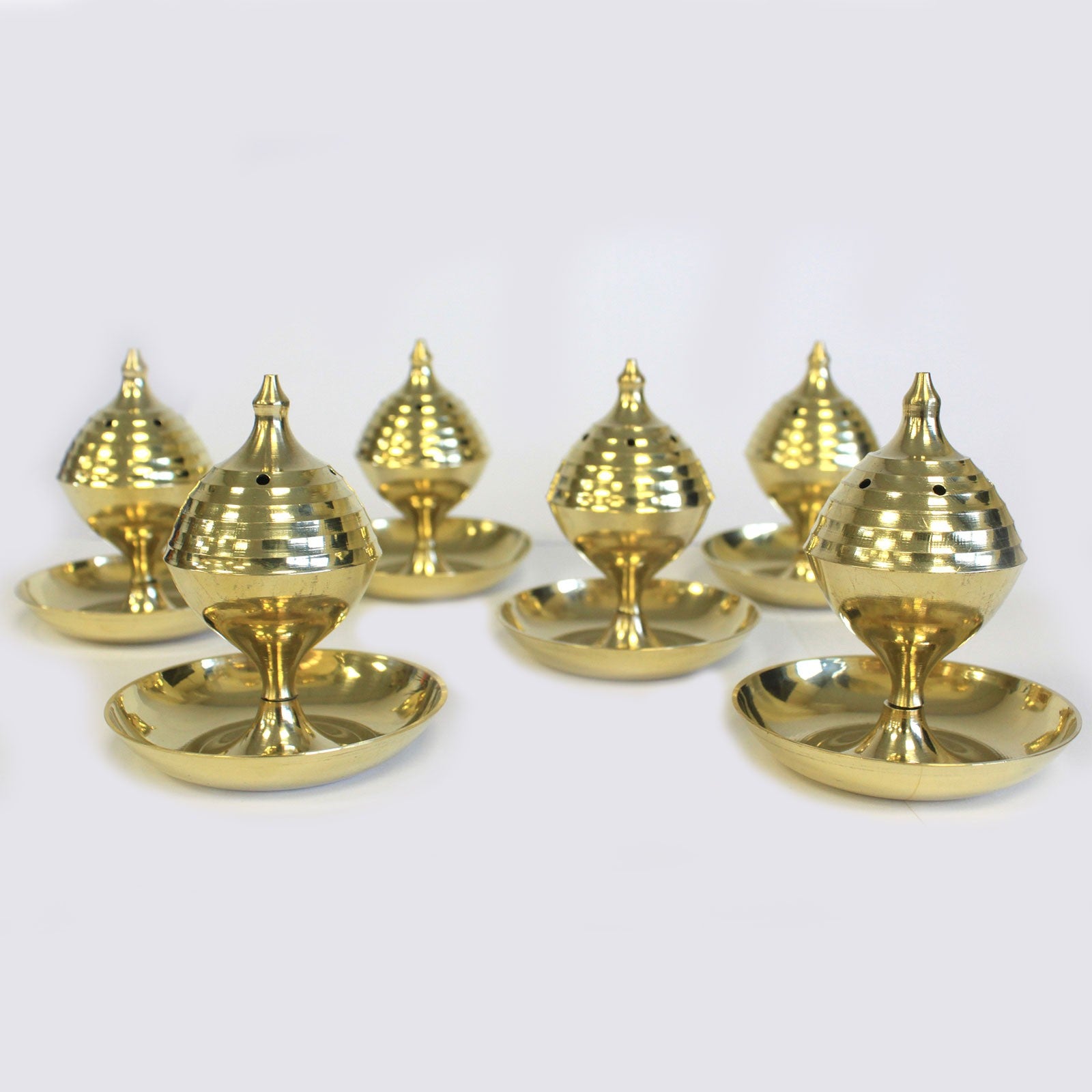 Image shows 6 brass incense burners neatly presented.