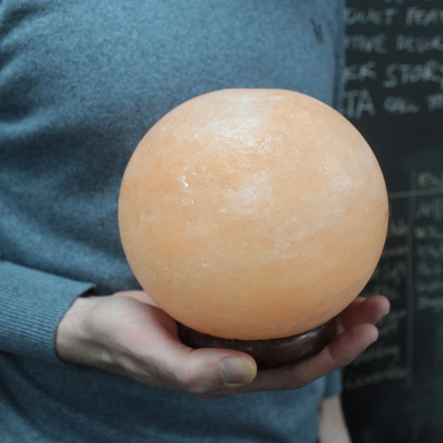 Image of salt lamp ball in mans hand