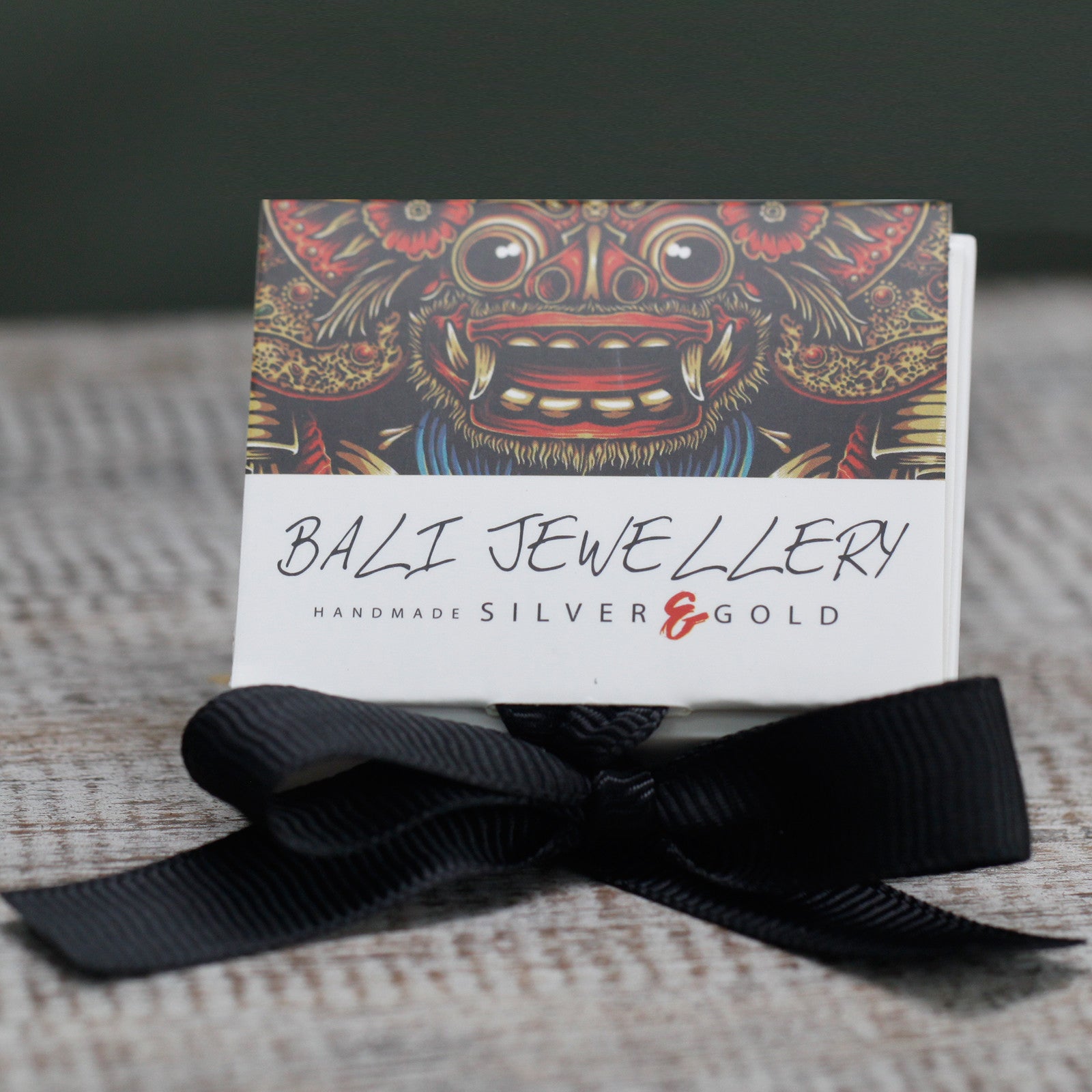 Image shows label, Bali Jewellery and black bow