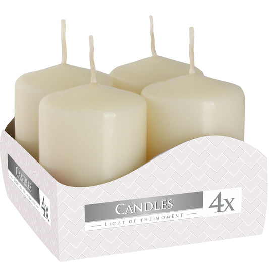 Close up of box containing 4 x Ivory colour pillar candles 