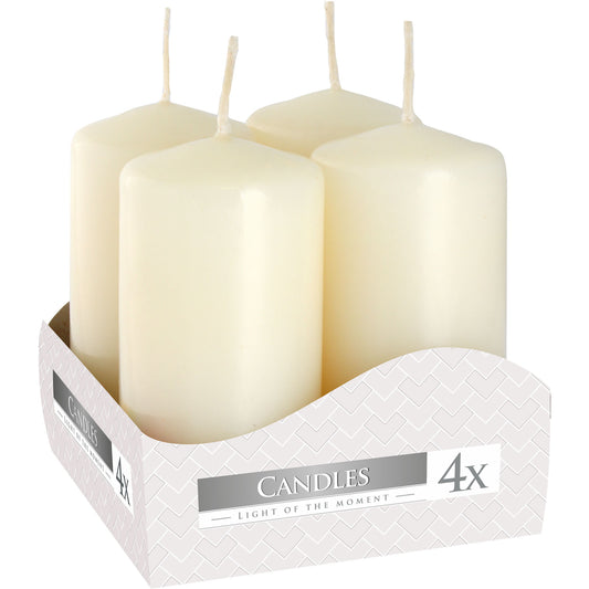 Close up of box containing 4 x Ivory colour pillar candles