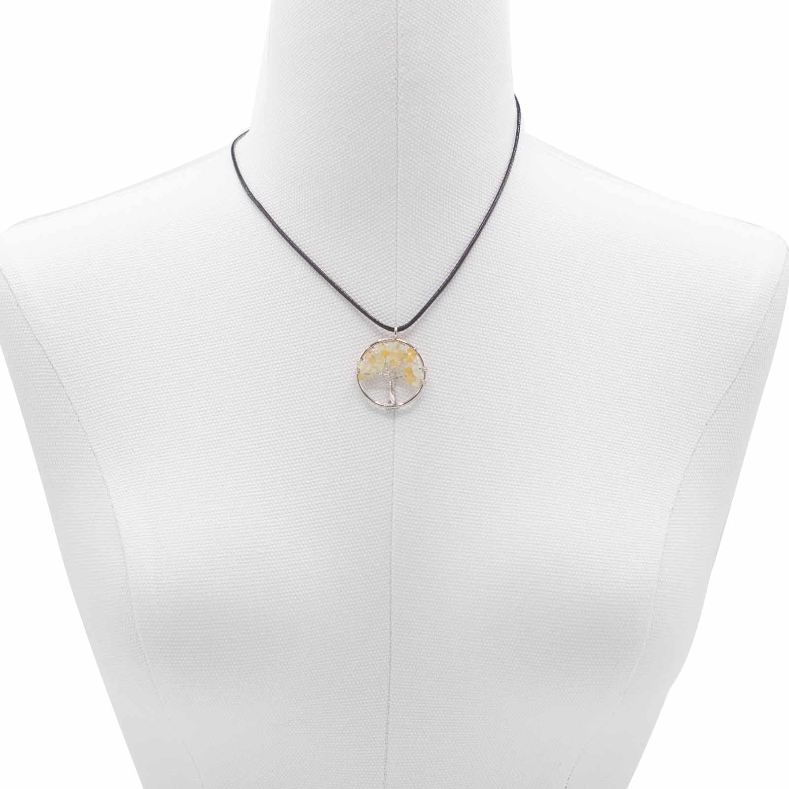 Image of a women's tree of life pendant featuring beautiful Carnelian gemstones, symbolizing elegance and sophistication. Front close up image on model bust