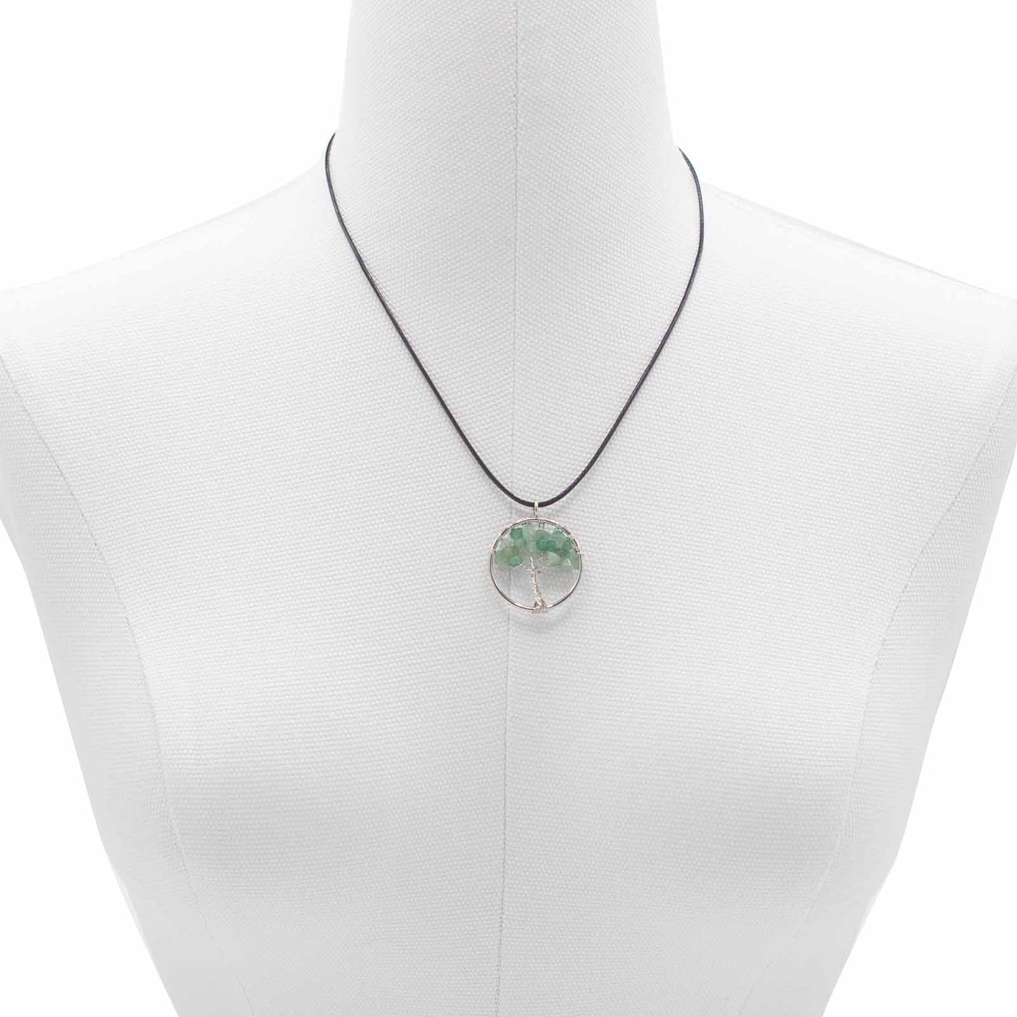 Image of a women's tree of life pendant featuring beautiful Jade gemstones, symbolizing elegance and sophistication. Front close up image on a model bust