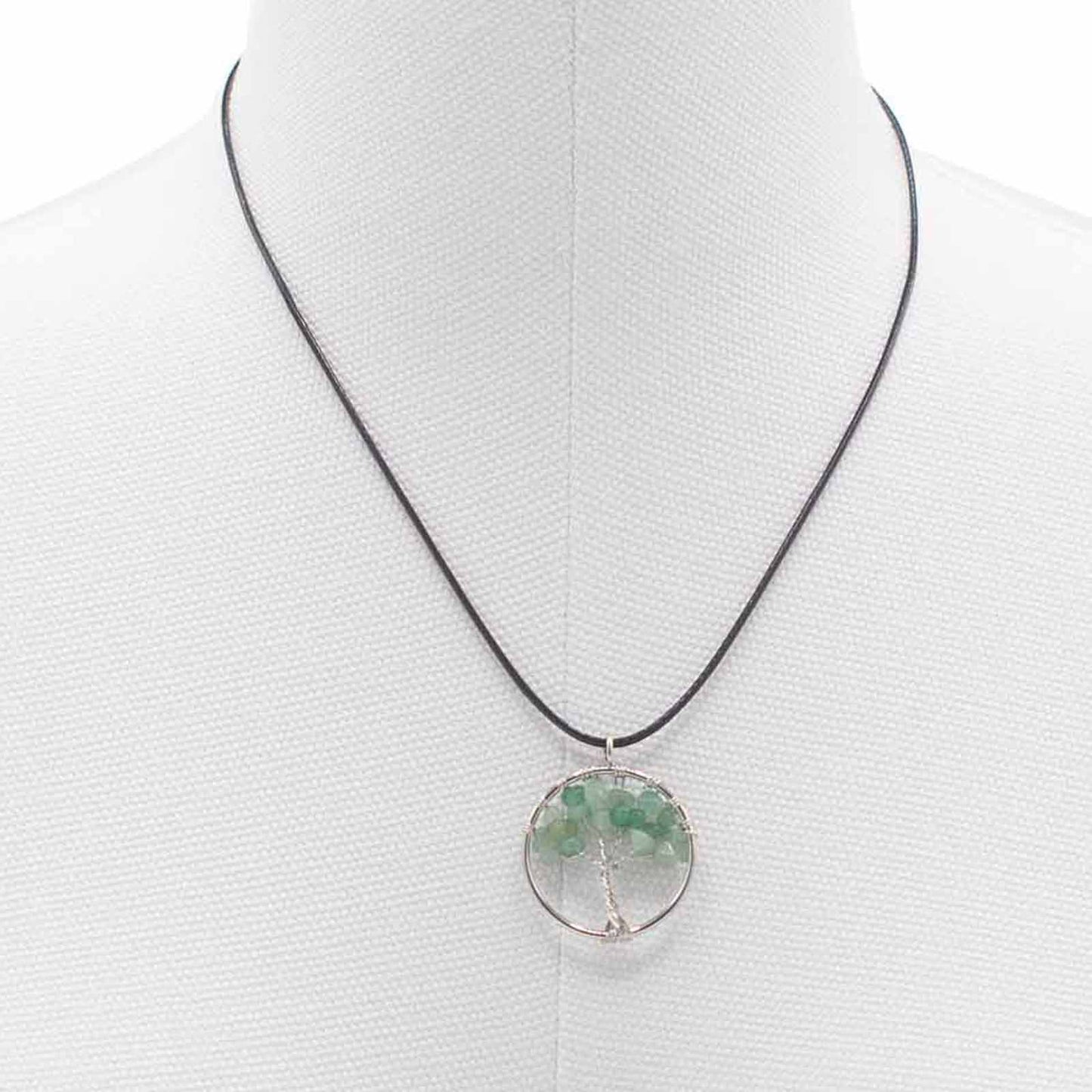 Image of a women's tree of life pendant featuring beautiful Jade gemstones, symbolizing elegance and sophistication. Front close up image on a white model bust