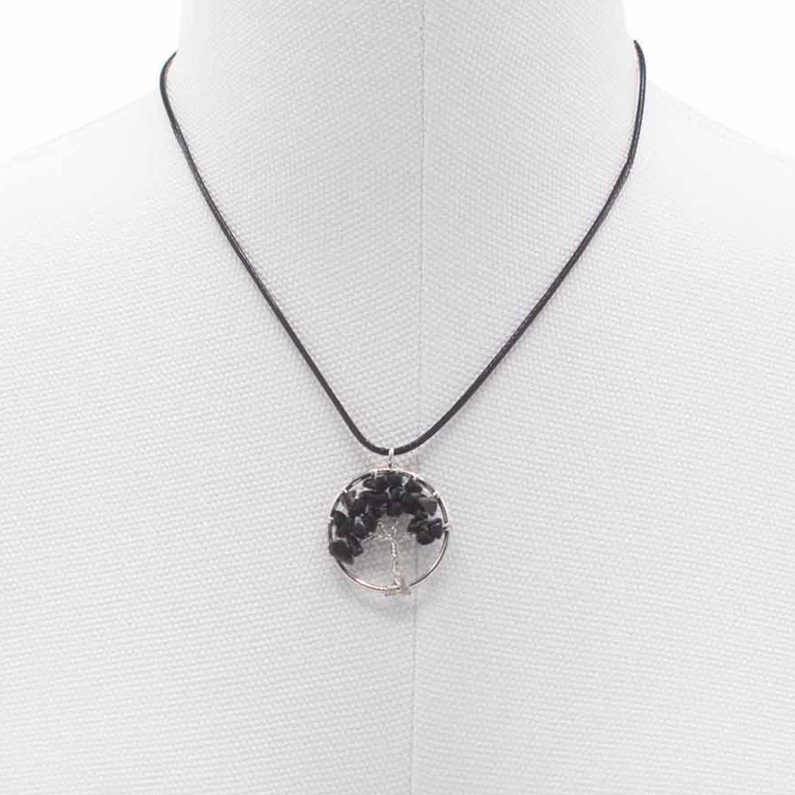 Close up image of pendant, tree of life black agate, around neck of shop dummy.