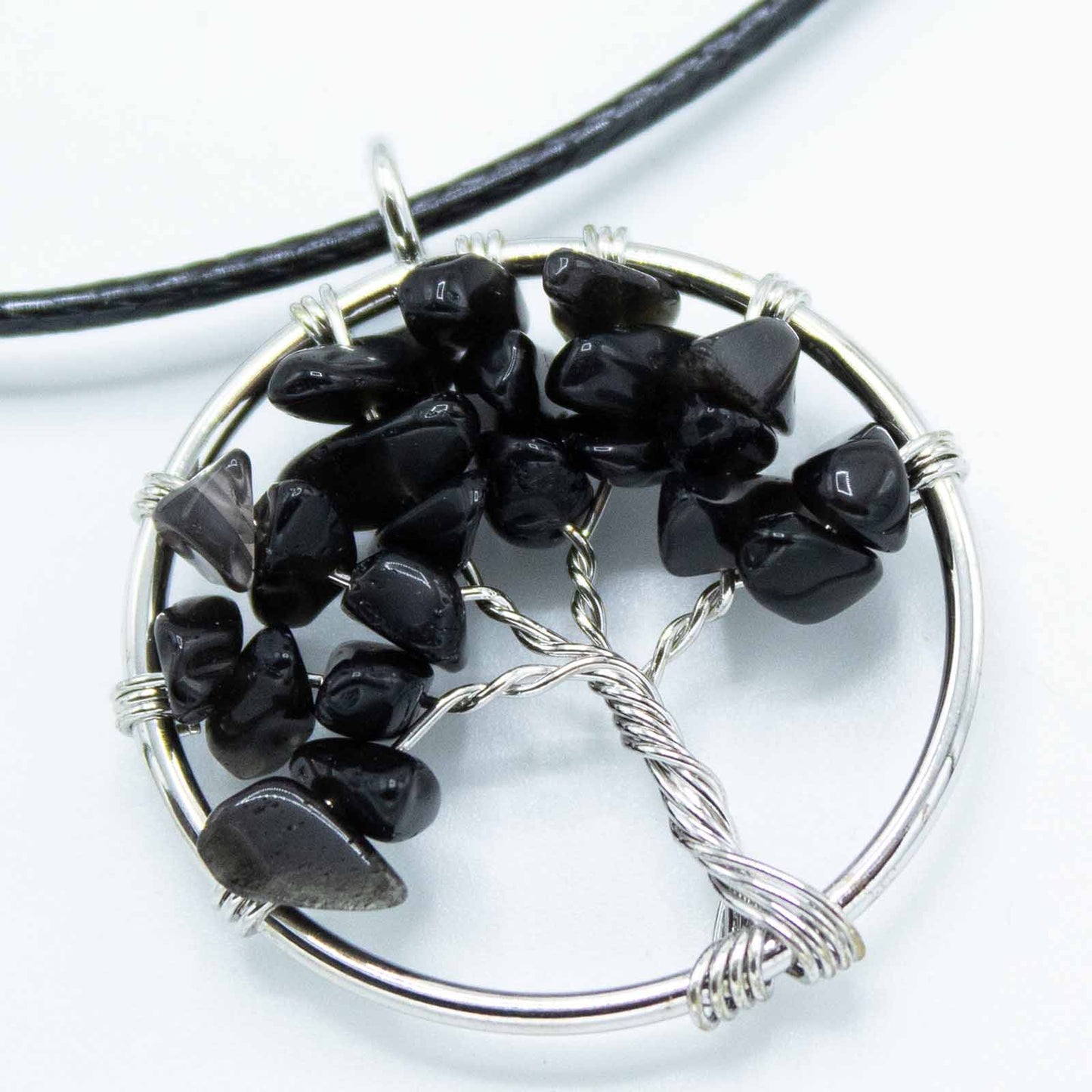 Image of Black Agate Tree of Life Pendant, symbolizing strength and resilience, perfect for elevating your style. Close up image, jewellery for women