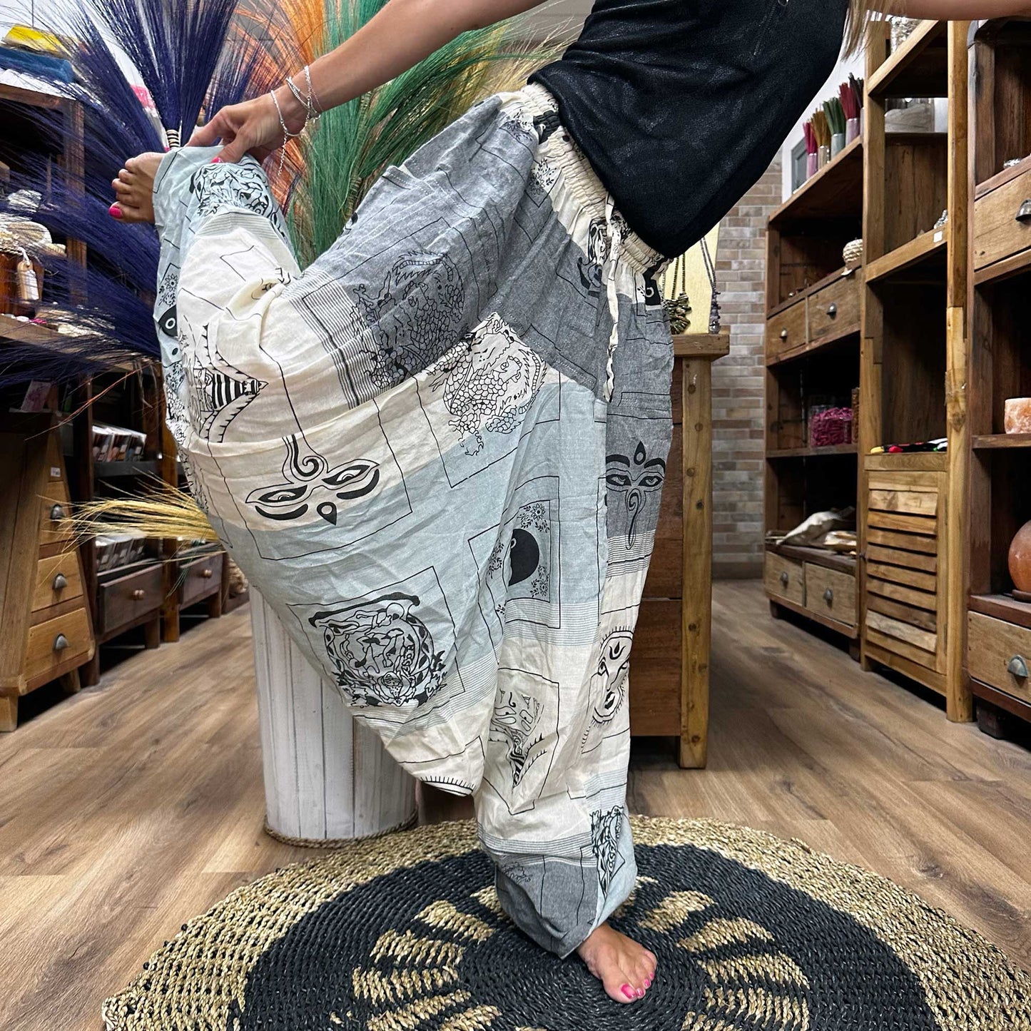 Someone doing the dancers pose wearing the Aladdin Yoga & Festival Pants, himalayan print on grey