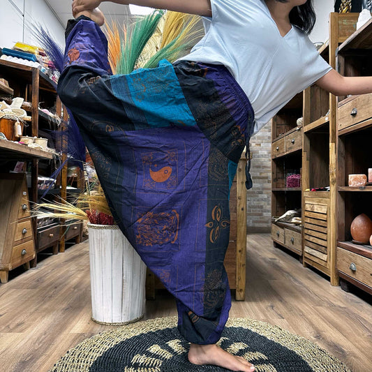 Someone doing the dancers pose wearing the Aladdin Yoga & Festival Pants, himalayan print on purple