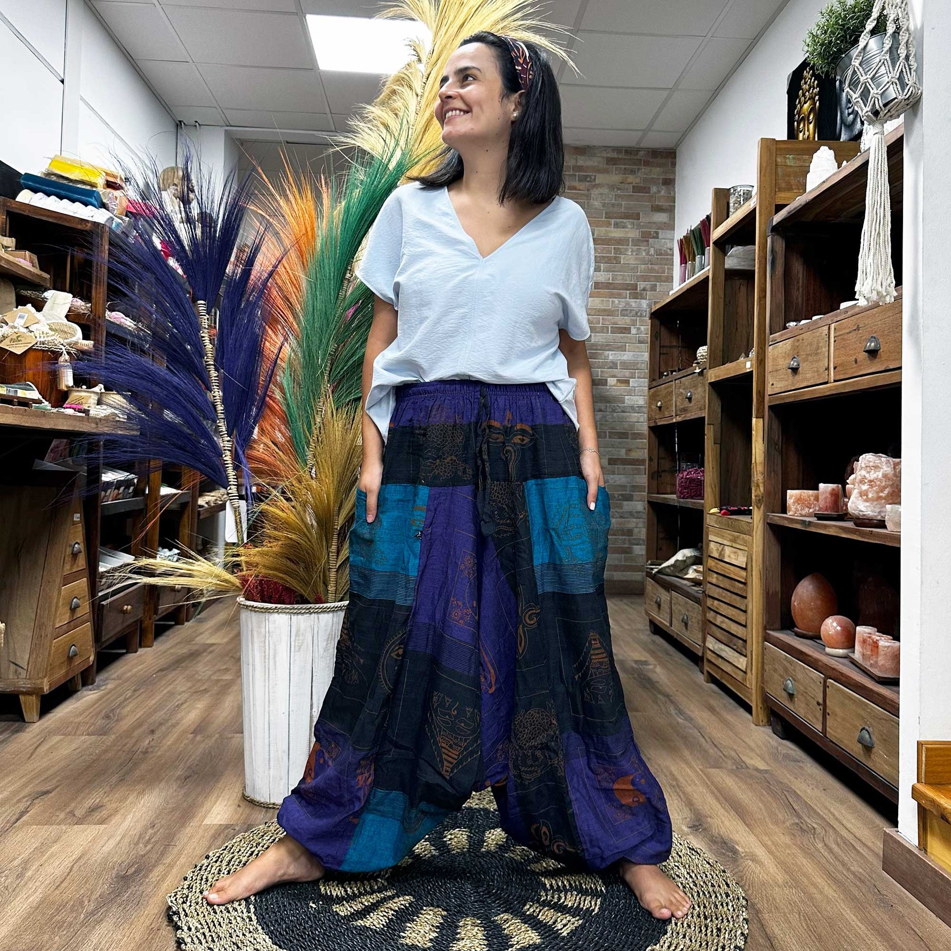 Front view of someone wearing the Aladdin Yoga & Festival Pants, himalayan print on purple