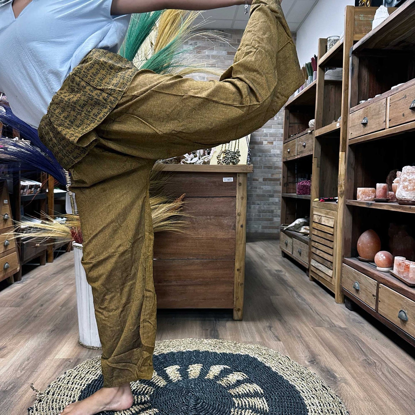 Person doing the dancers pose wearing unisex Thai Fisherman yoga pants made from 100% cotton, mandala mantra on orange