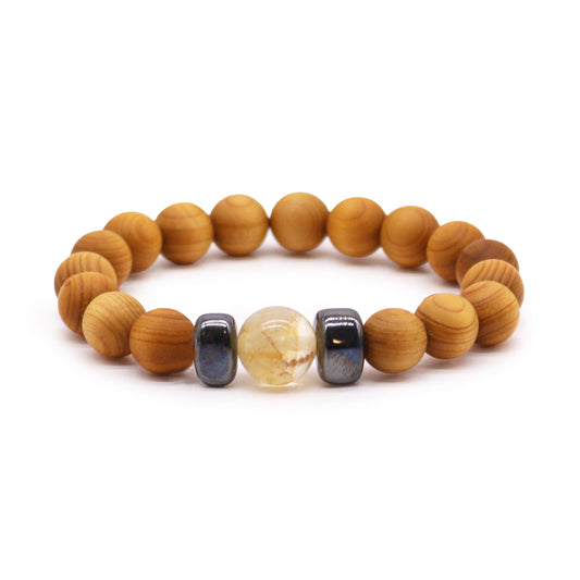 Cedar wood solar plexus chakra bangle with citrine gemstone. Handcrafted cedarwood solar plexus chakra bracelet with citrine gemstones. Eco-friendly unisex jewelry for empowerment and positivity. Shop now in the UK! Image with bracelet on white background