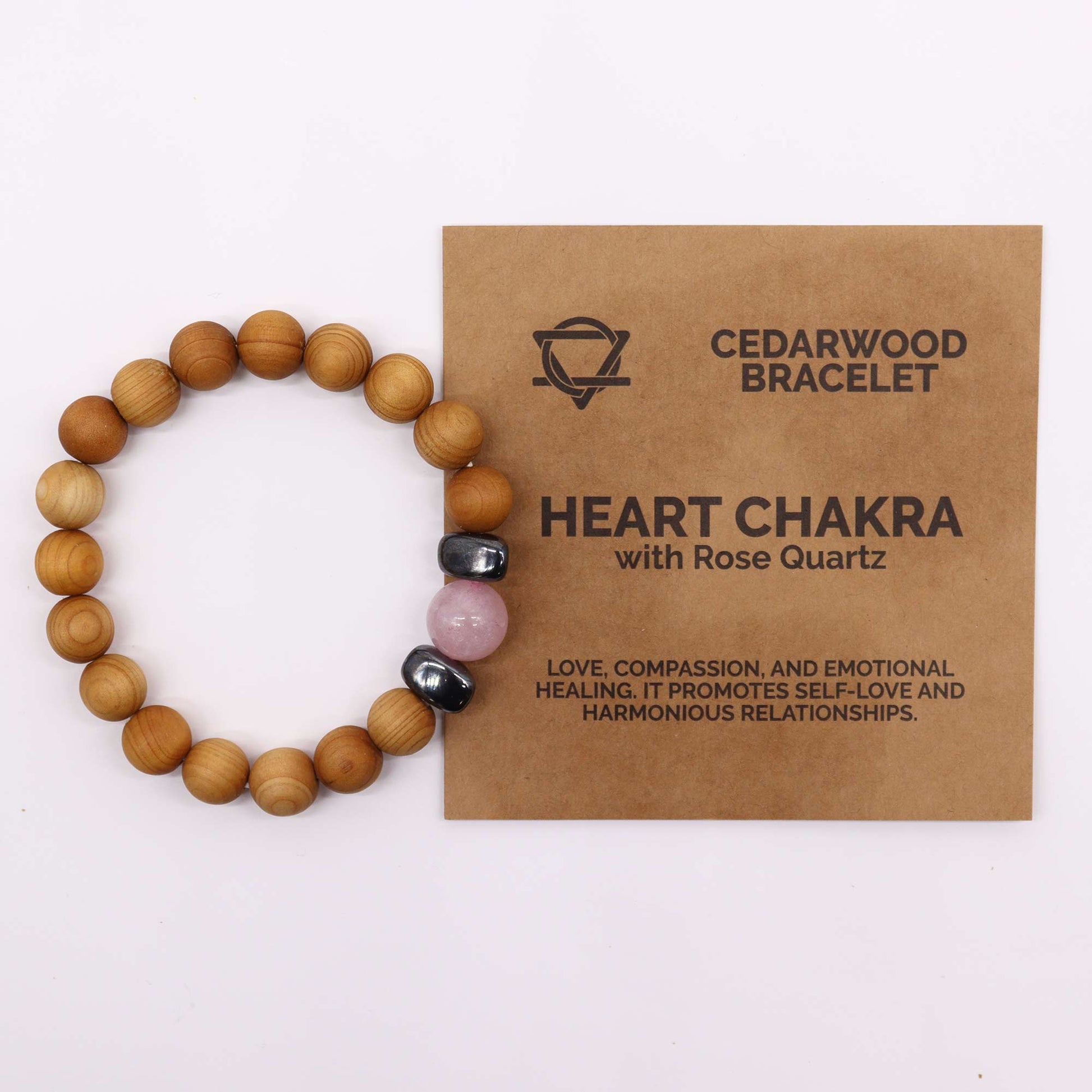 Rose Quartz gemstone. Handmade cedarwood and gemstone unisex bracelet with 7cm diameter, featuring natural wooden beads and vibrant gemstones, eco-friendly and stylish. Image shows bracelet alongside brown packaging