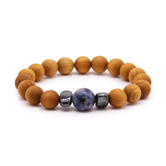 Handcrafted cedarwood throat chakra bangle with Sodalite gemstones. Eco-friendly unisex jewelry for spiritual balance. Shop now! Image of bracelet on white background