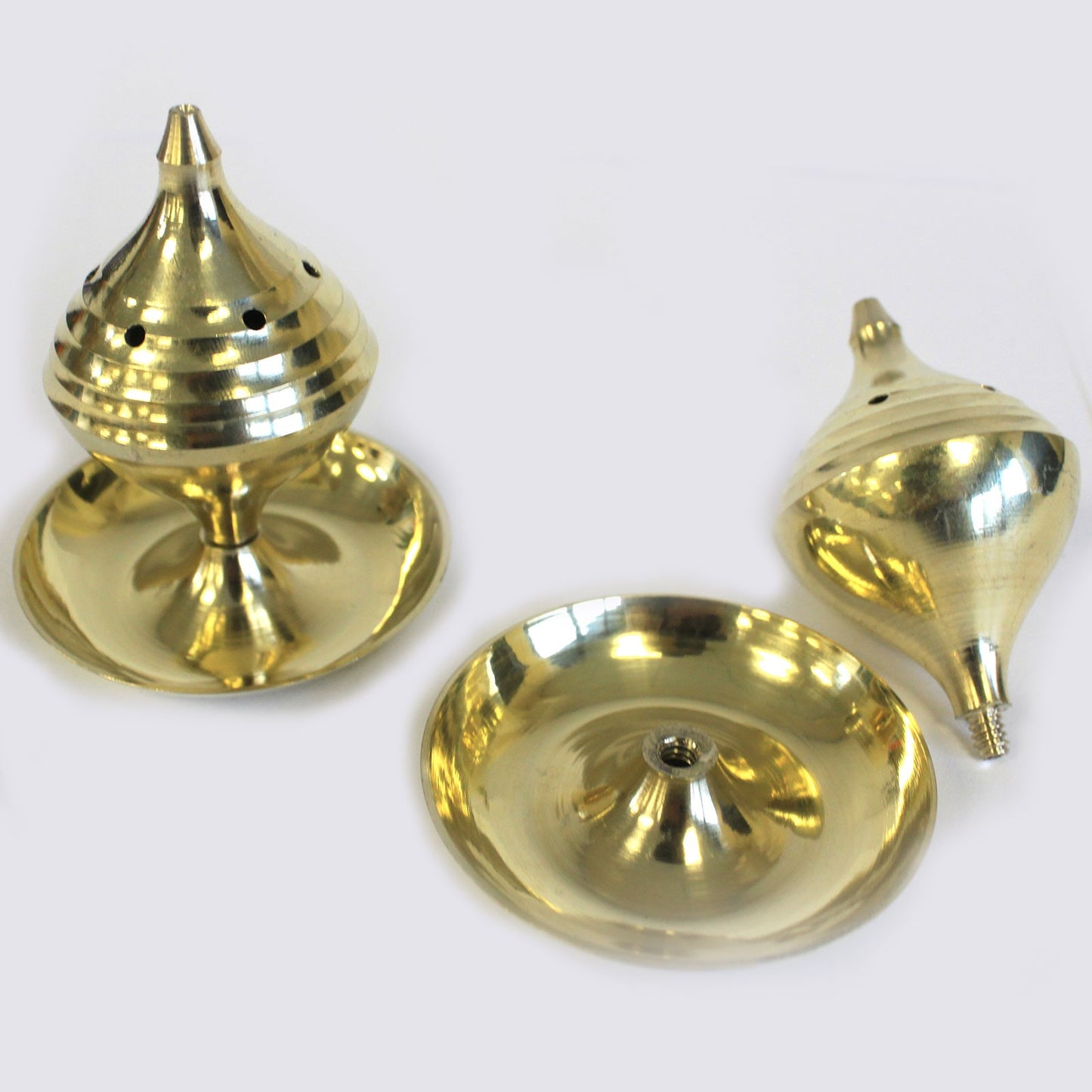 Image of two incense burners, holders in brass, one burner shows how it is taken apart