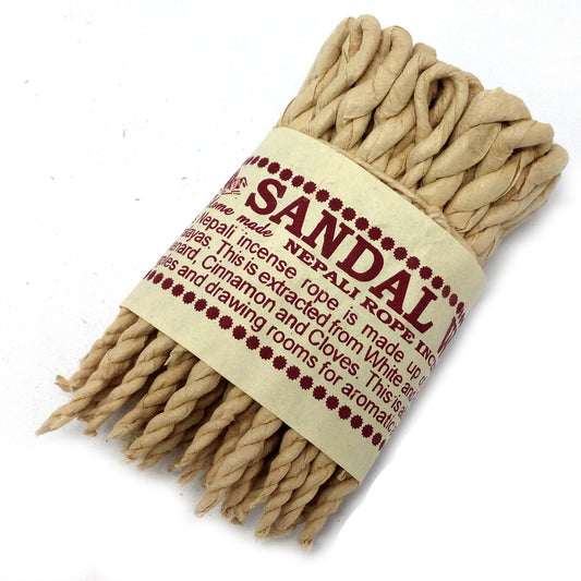 Image of aromatic sandalwood and spice  incense rope coiled on a surface, symbolising tranquility and meditation.