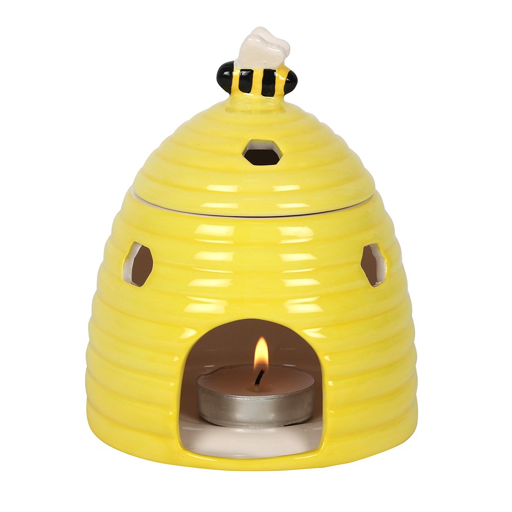 close up of yellow beehive oil burner with a tealight inside