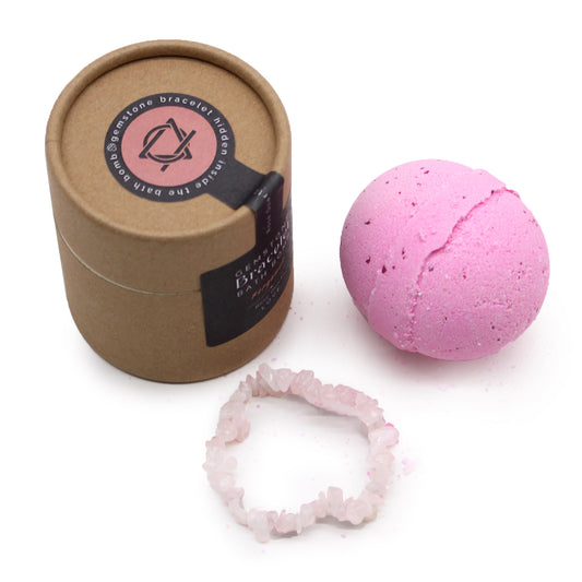 Image of eco friendly box and rose quartz bracelet, next to round purple bath bomb