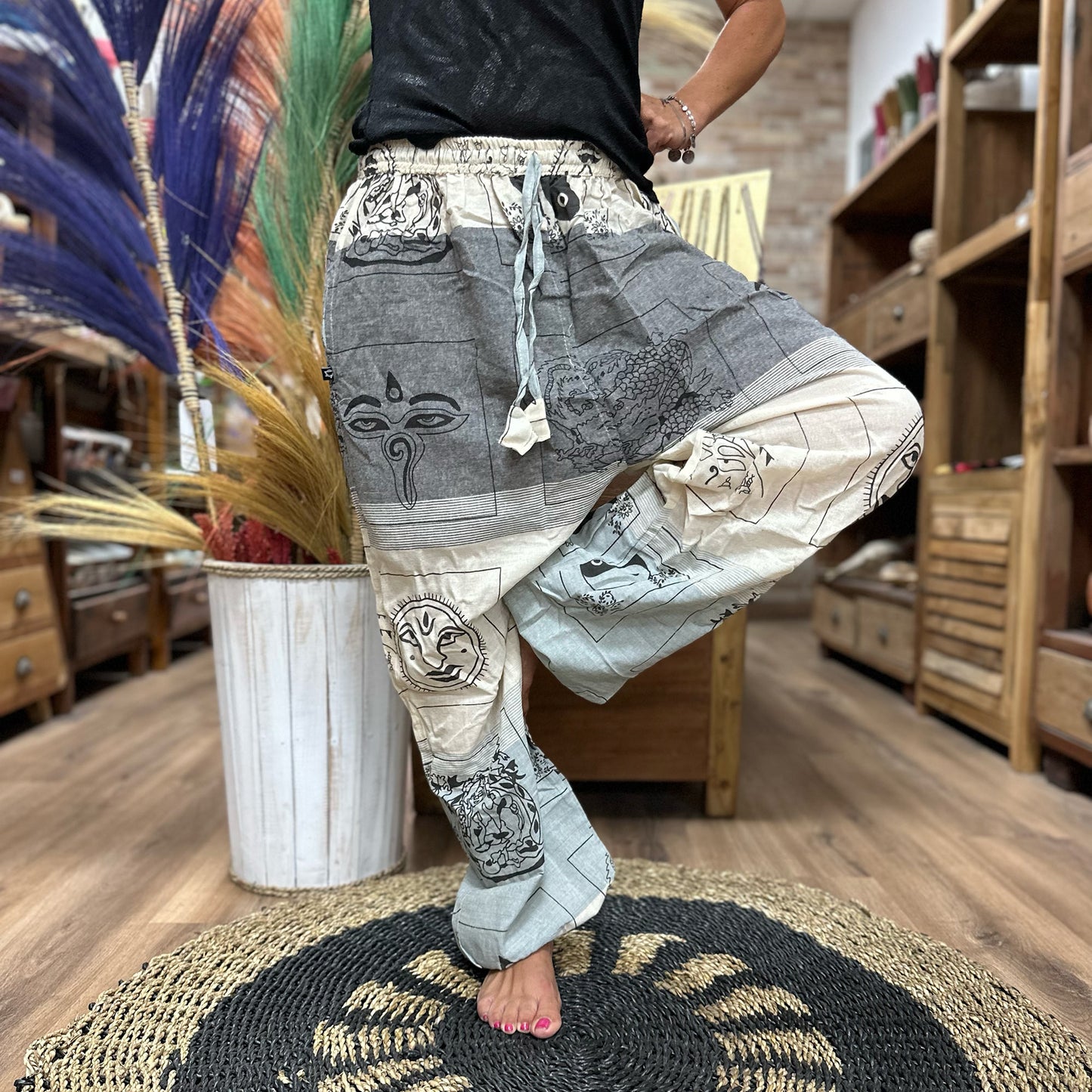 Person balancing on leg wearing High Cross Yoga & Festival Pants, Himalayan print on grey