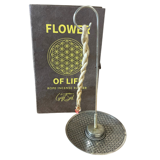 Image shows rope incense flowers of life. Silver holder holding the rope incense