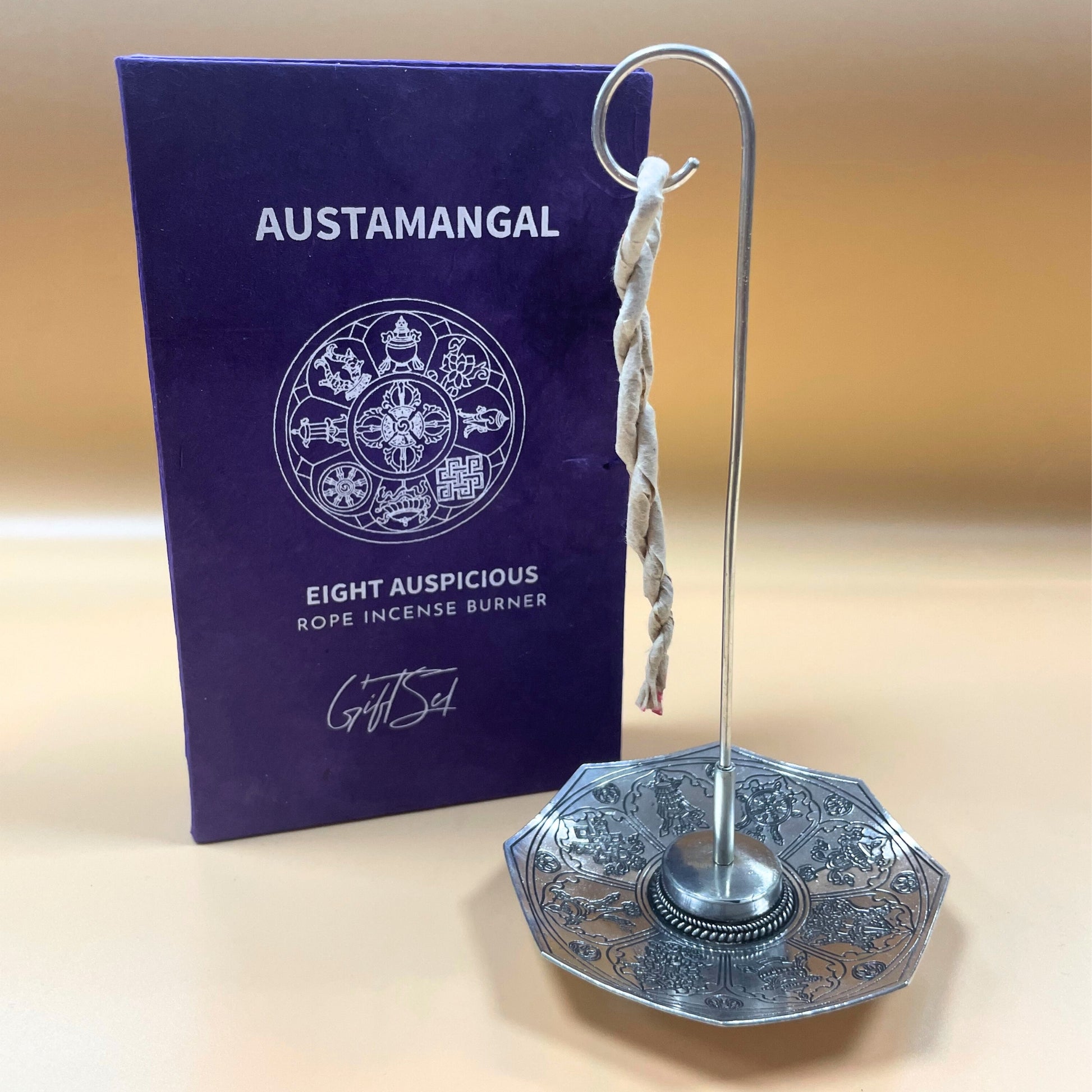 Image shows Austamangal rope incense burner, silver plated holder holding rope incense, close up image